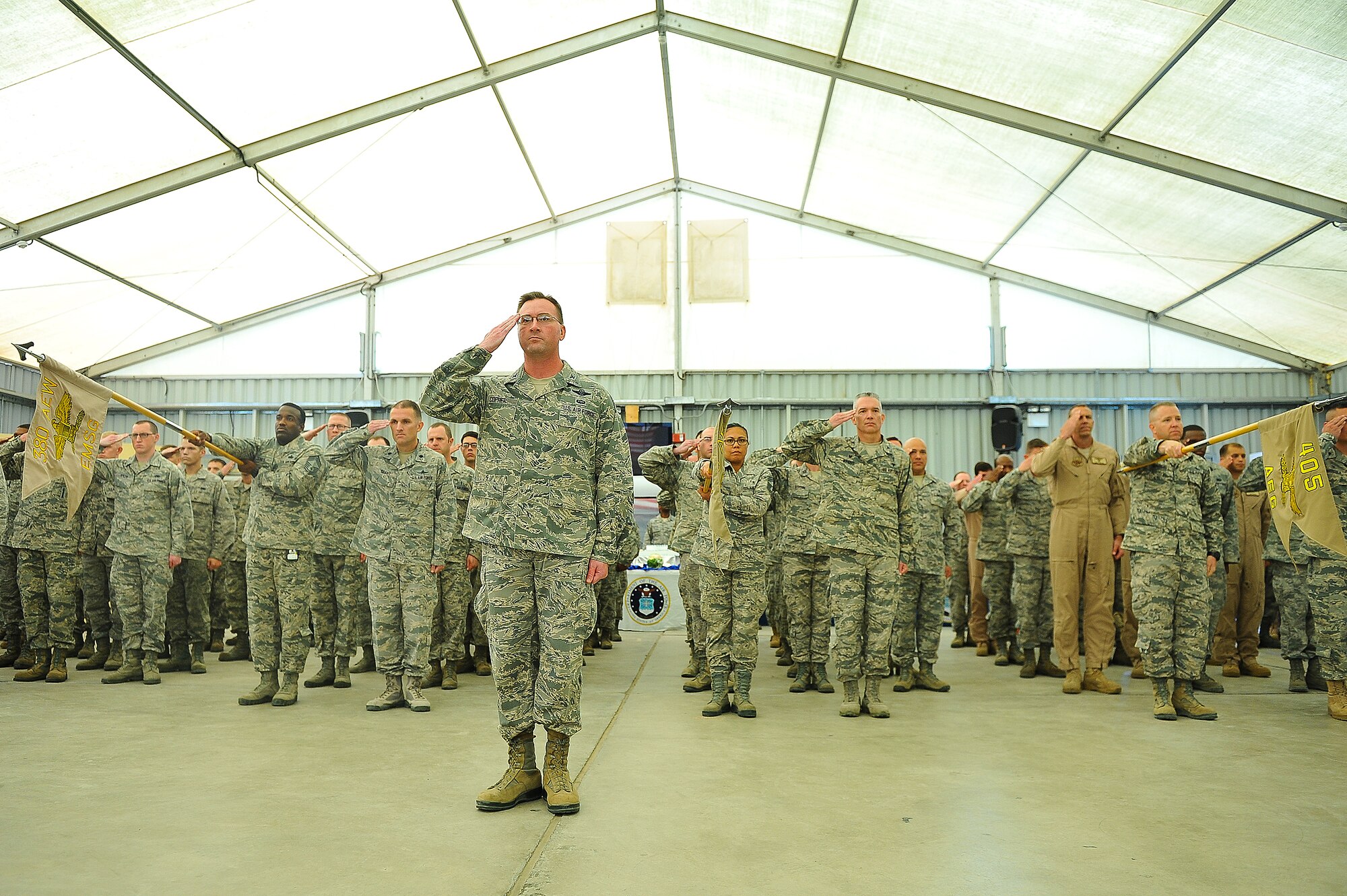 Col. James Copher, 380th Air Expeditionary Wing vice commander, leads a formation of Airmen saluting Brig. Gen. Kevin Schneider, 380th Air Expeditionary Wing commander, for the final time at an undisclosed location in Southwest Asia June 18, 2014. Schneider was succeeded in command by Brig. Gen. John Quintas. (U.S. Air Force photo by Tech. Sgt. Russ Scalf/Released)