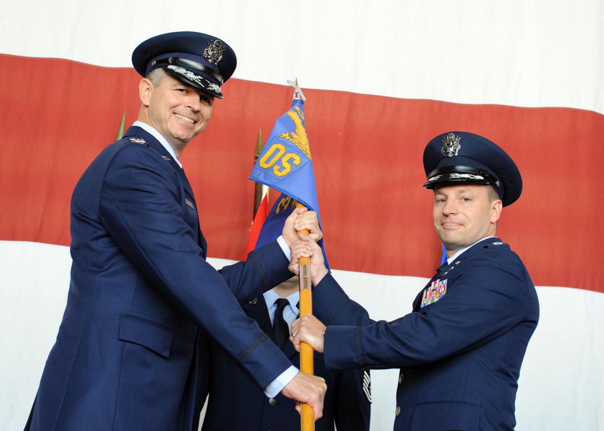 Col. Craig Wills, 39th Air Base Wing commander, passes the guideon to Lt. Col. Kyle Wilson, 39th Operations Squadron commander, June 17, 2014, Incirlik Air Base, Turkey.The ceremony signified the transition of command from Lt. Col. John Vincent to Wilson. (U.S. Air Force photo by Staff Sgt. Eboni Reams/Released) 
