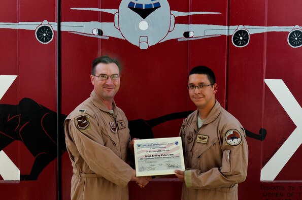 Col. James Copher, 380th Air Expeditionary Wing vice commander, presents Staff Sgt. Jeffery Echeverry, 968 Expeditionary Airborne Air Control Squadron, a warrior of the week certificate at an undisclosed location in Southwest Asia, May 28, 2014. Echeverry, a native of Ocala, Fla., is deployed from Tinker Air Force Base, Okla. (U.S. Air Force photo by Maj. Jefferson S. Heiland)