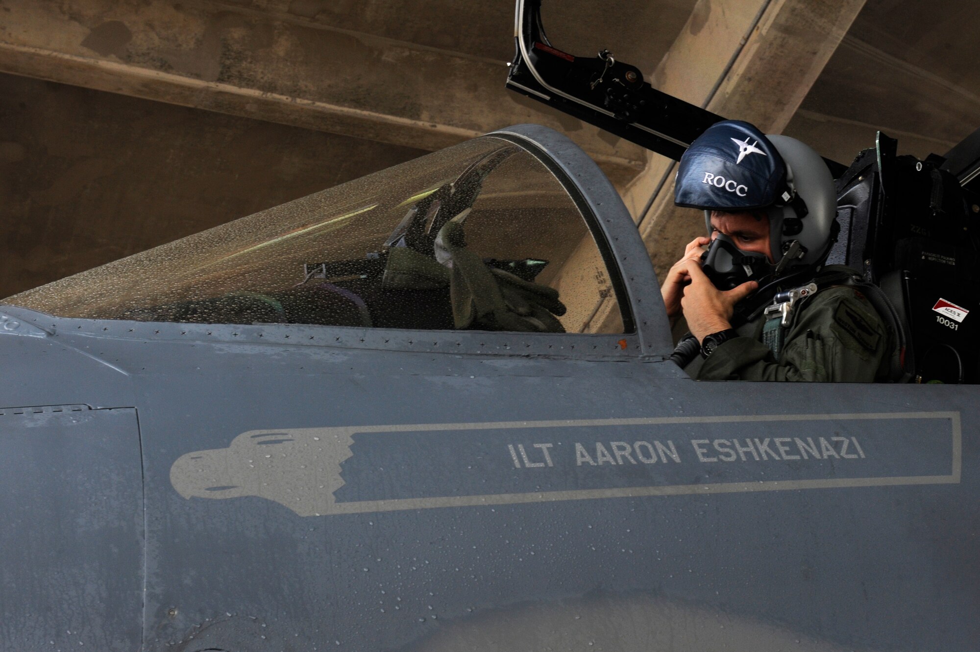U.S. Air Force Maj. Weston Turner, 18th Operations Support Squadron F-15C Eagle instructor pilot, dons his face mask before takeoff for aviation training relocation to Guam on Kadena Air Base, Japan, June 18, 2014. The ATR provides service members from Kadena the opportunity to integrate with Pacific Air Forces units in the region and strengthen the U.S. Air Force's ability to respond to a potential threat in the region. The repositioning also relieves the noise impact of Kadena jets on the local community. (U.S. Air Force photo by Senior Airman Maeson L. Elleman)