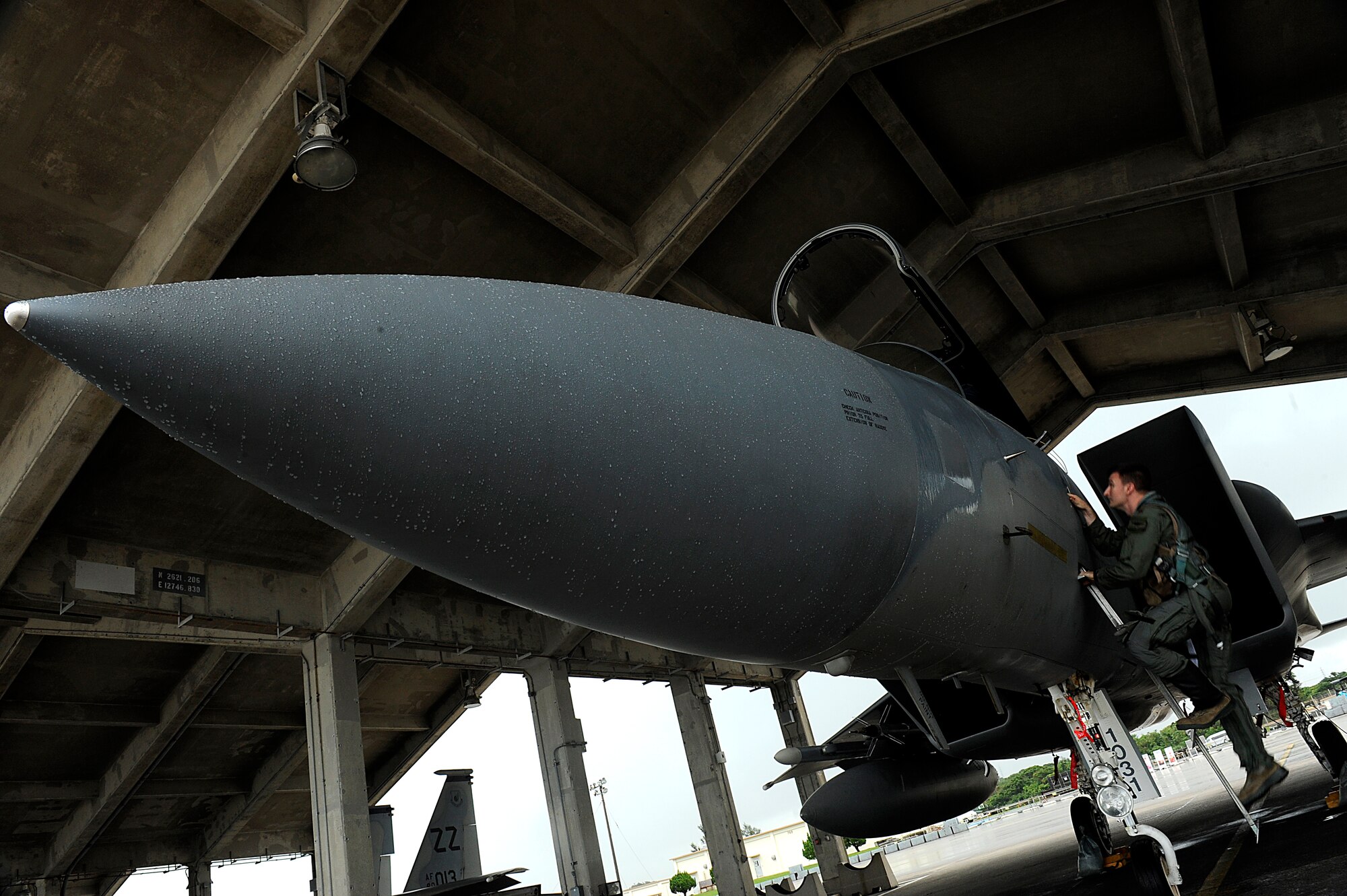 U.S. Air Force Maj. Weston Turner, 18th Operations Support Squadron F-15C Eagle instructor pilot, climbs into his jet before takeoff for aviation training relocation to Guam on Kadena Air Base, Japan, June 18, 2014. As part of the ATR, service members, aircraft and equipment from the 44th FS, 909th Air Refueling Squadron and 961st Airborne Air Control Squadron repositioned to Andersen Air Force Base, Guam, in order to promote integration and readiness. (U.S. Air Force photo by Senior Airman Maeson L. Elleman)