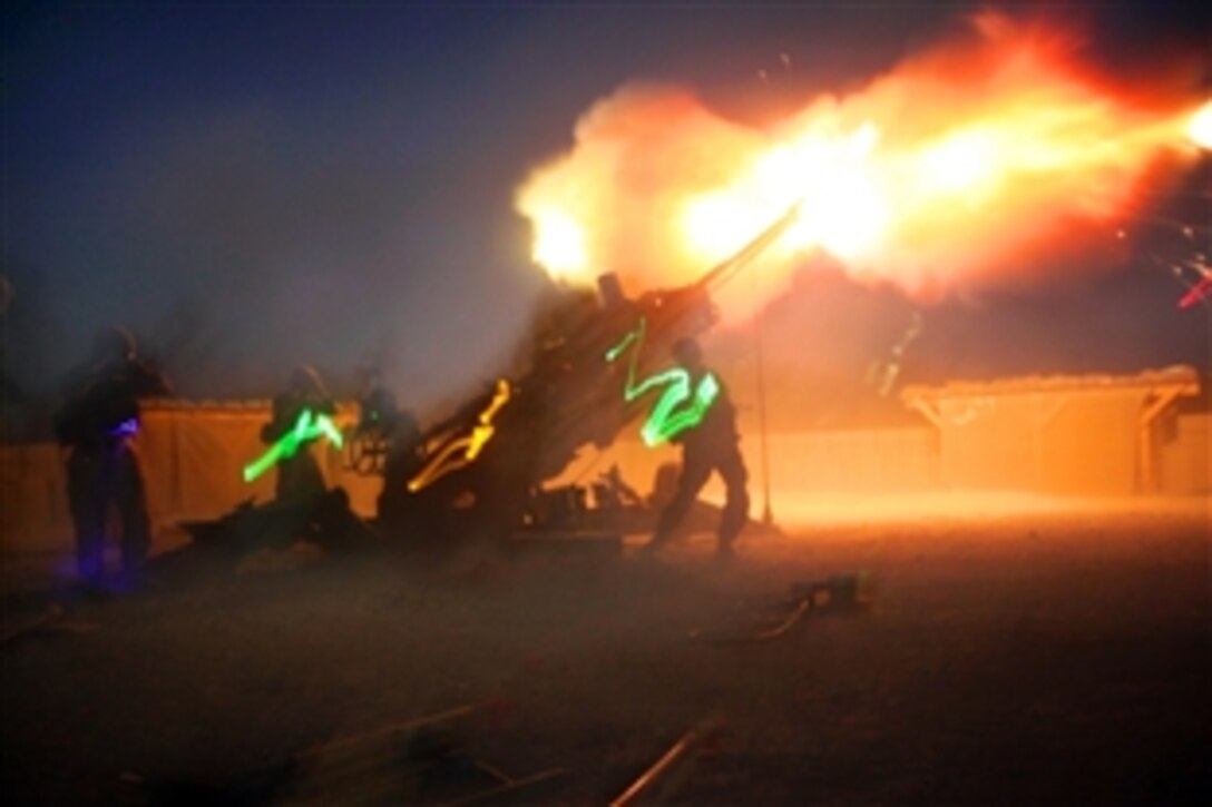 U.S. Marines fire their M777A2 howitzer during a fire mission on Camp Bastion, Afghanistan, June 13, 2014. The Marines are assigned to the High Mobility Artillery Rocket System Platoon, Tango Battery, 5th Battalion, 11th Marine Regiment.