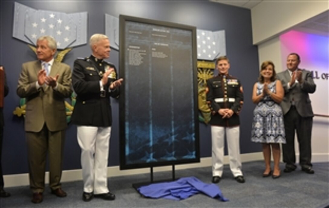 Defense Secretary Chuck Hagel greets Medal of Honor recipient retired Marine Corps Cpl. William “Kyle” Carpenter during a Hall of Heroes induction ceremony at the Pentagon, June 20, 2014. President Barack Obama presented Carpenter with the Medal of Honor at the White House a day earlier, for his actions while deployed in Marjah, Helmand Province, Afghanistan, in 2010.