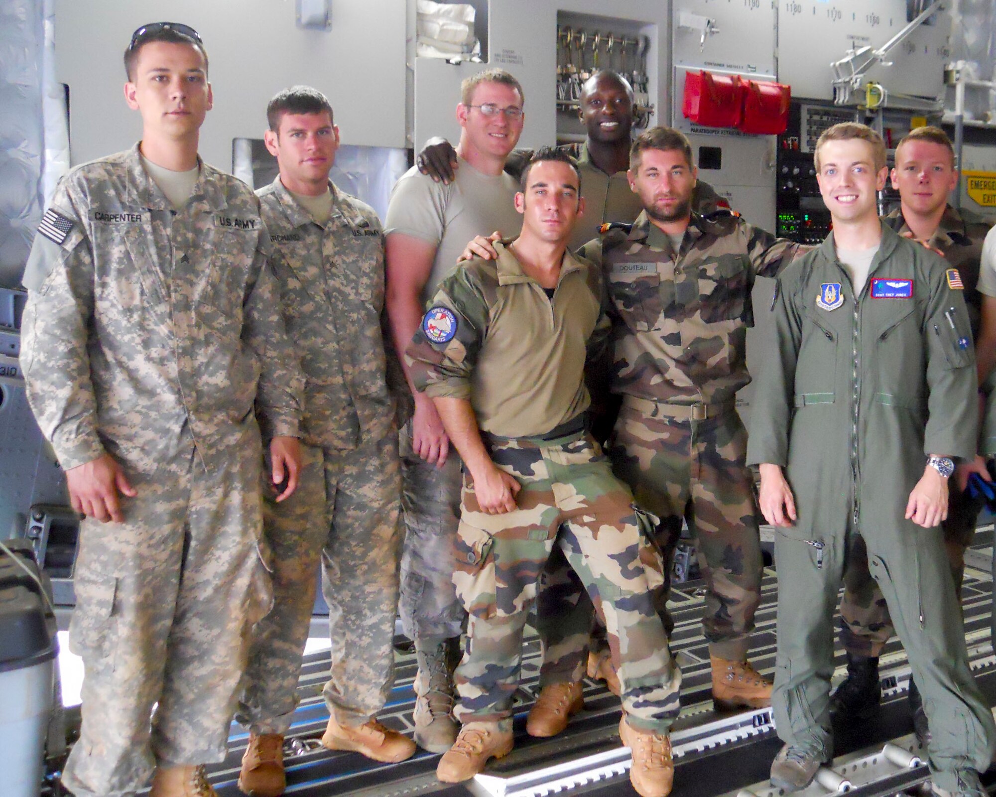 Reservists from the 701st Airlift Squadron at Joint Base Charleston, S.C. stand in the back of a C-17 Globemaster III aircraft with U.S and international mission partners while providing airlift support for the African-led International Support Mission in the Central African Republic (MISCA) June 10, 2014. The mission spanned several days with several stops at multiple countries bringing people, food and equipment to CAR. Mission partners consisted of personnel from the U.S. Army and French military. (U.S. Air Force photo/Chief MSgt. Gigi Manning)