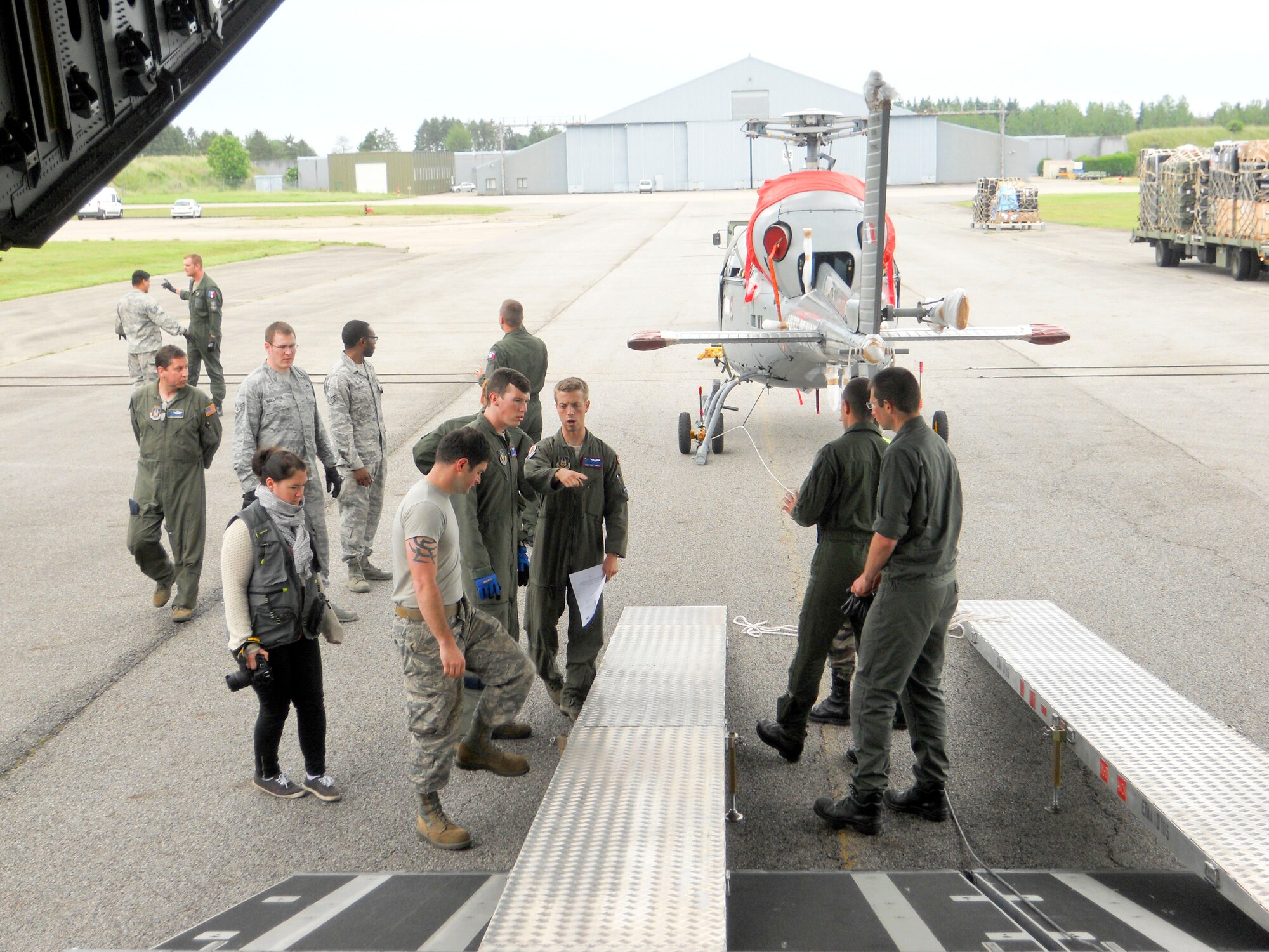 Reservists from the 701st Airlift Squadron at Joint Base Charleston, S.C. prepare to load a helicopter into the back of a C-17 Globemaster III aircraft while providing airlift support for the African-led International Support Mission in the Central African Republic (MISCA) June 10, 2014. The mission spanned several days with several stops at multiple countries bringing people, food and equipment to CAR. Mission partners consisted of personnel from the U.S. Army and French military. (U.S. Air Force photo/Chief MSgt. Gigi Manning)