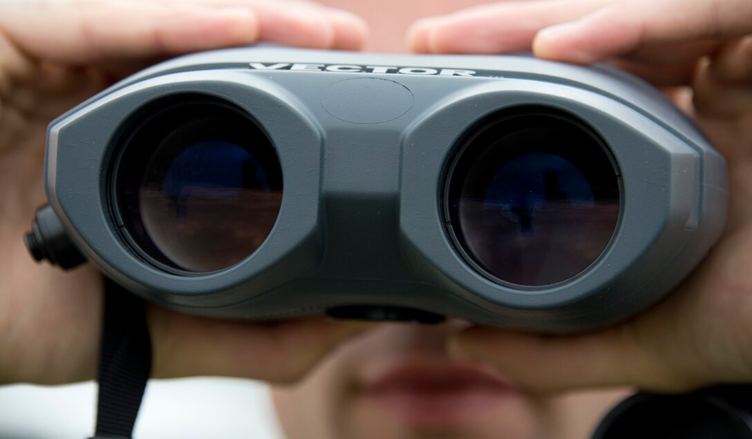 U.S. Air Force Senior Airman Timothy Wigton, 208th Weather Flight, gazes through a Laser Range Finder (LRF) in Little Falls, Minn., June 12, 2014. Wigton operates the LRF to determine the distance of objects during periods of adverse weather conditions. This helps insure the safety of aircraft throughout landing and take-off.

(U.S. Air National Guard photo by Tech. Sgt. Amy M. Lovgren/Released)