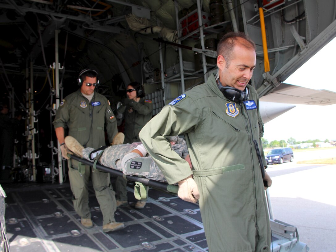 In June numerous members of the 932nd Airlift Wing worked together during a five-day joint training field exercise. Members of the 932nd Airlift Wing Medical Group, 932nd Aeromedical Evacuation Squadron and the Army Reserve 325th Combat Support Hospital (in Missouri) participated in the exercise at Scott Air Force Base.   The purpose of the exercise was to coordinate each component used for medical care in a deployment setting, and simulate real world scenarios to give military service members the opportunity to use their training and equipment to provide immediate care to injured people on site. The 434th Air Refueling Wing at Grissom Air Reserve Base, Indiana, supplied a KC-135 and the 302nd Airlift Wing at Peterson Air Force Base, CO supplied a C-130 for patient transport scenarios during the exercise. 
 " There is no way you can build a clear understanding of what you are doing in a real world mission without the muscle memory that comes from practice," said Maj. Carlton Abner a Medical Crew Director with the 932nd AES.  "Any chance you get to play with other units or moving pieces, the better prepared you are for the real world." (U.S. Air Force Photo/Staff. Sgt. Meiko Schill)