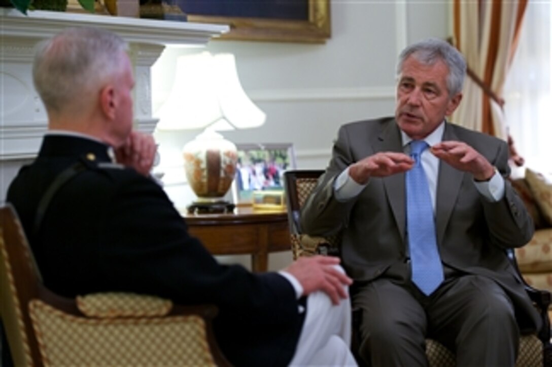 Defense Secretary Chuck Hagel and Marine Corps Commandant Gen. James F. Amos talk in the commandant's quarters before the Friday evening parade at Marine Barracks Washington, D.C. June 20, 2014. 