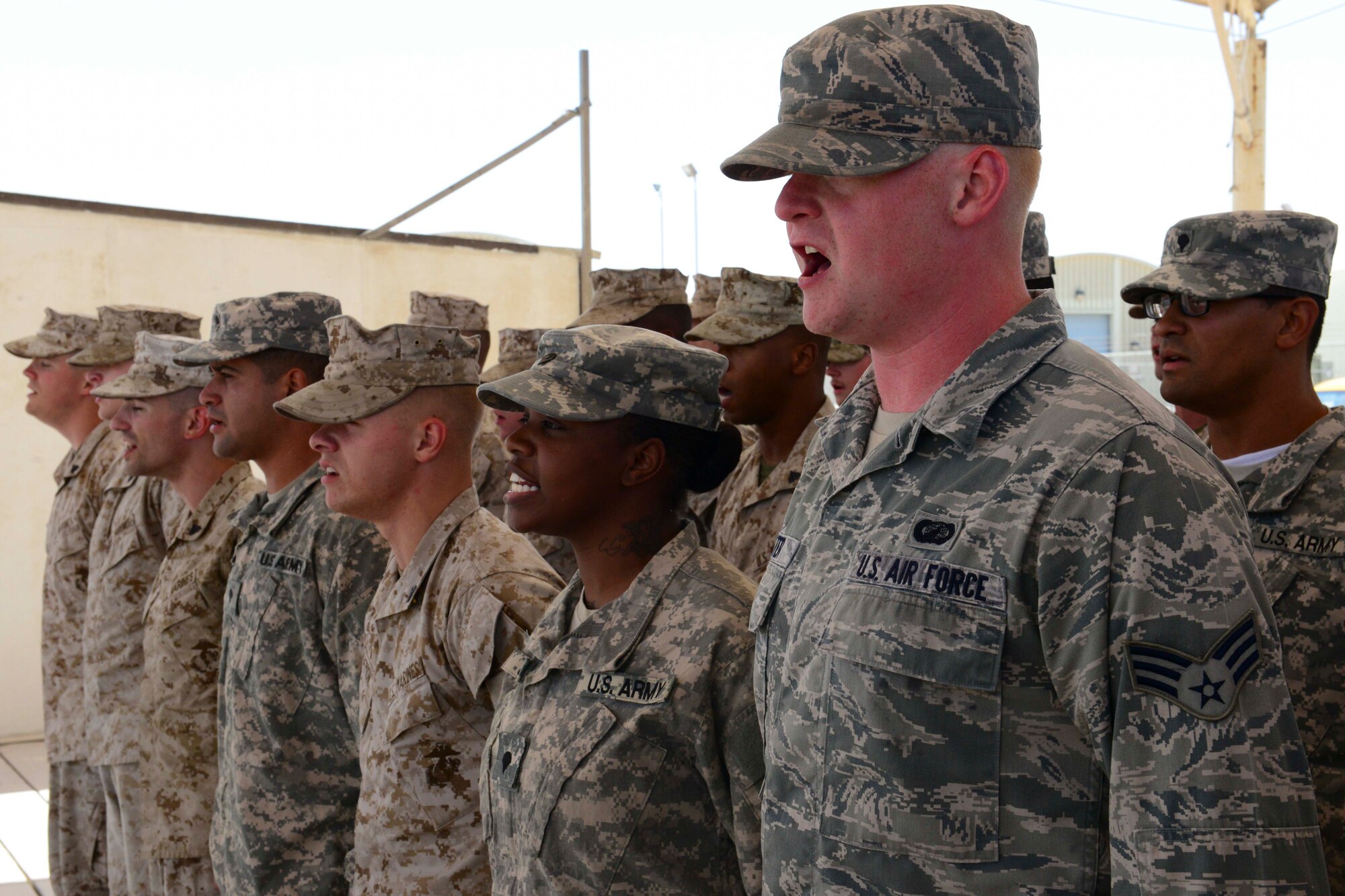 Senior Airman Luke Meister and other service members in a Corporal’s Course recite the Marine NCO creed June 16, 2014, at Al Udeid Air Base, Qatar. The service members were part of a 15-day Corporal’s Course designed to prepare them for leadership as they progress to the next rank. Meister is a 379th Expeditionary Contracting Squadron contracting officer. (U.S. Air Force photo/Staff Sgt. Ciara Wymbs) 