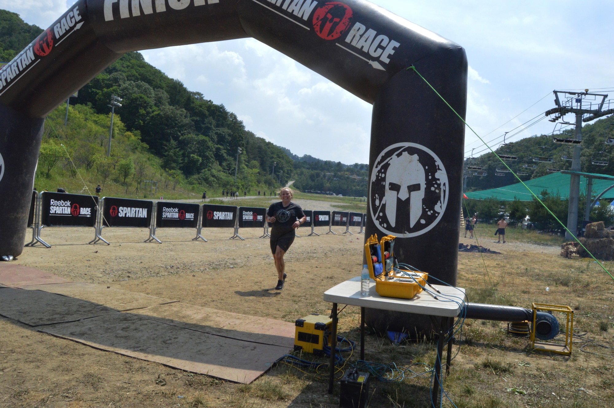 Maj. Susan Sheets, 51st Comptroller Squadron commander, crosses the finish line of a Spartan Race in Seoul, Republic of Korea, June 15, 2014. Spartan Race participants can receive a trifecta medal if they complete a Spartan Spring, Super Spartan and Spartan Beast run in one calendar year. (U.S. Air Force photo/Senior Airman Matthew Lancaster)