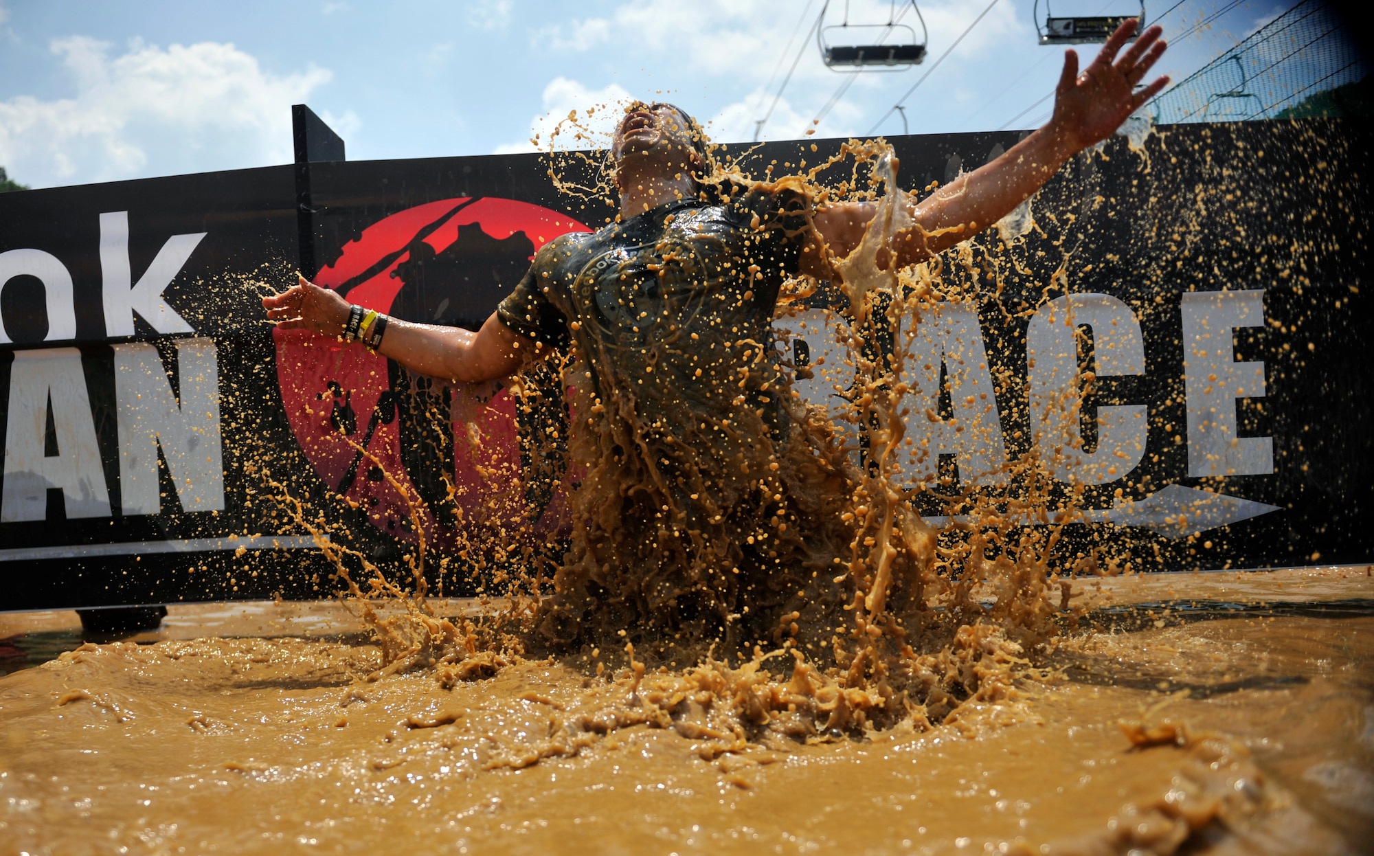 Master Sgt. Alfredo Benavides, 51st Fighter Wing Ground Safety manager, emerges from the muddy water during a Spartan Race in Seoul, Republic of Korea, June 15, 2014. Participants had to submerge themselves in the water during the obstacle. (U.S. Air Force photo/Senior Airman David Owsianka)