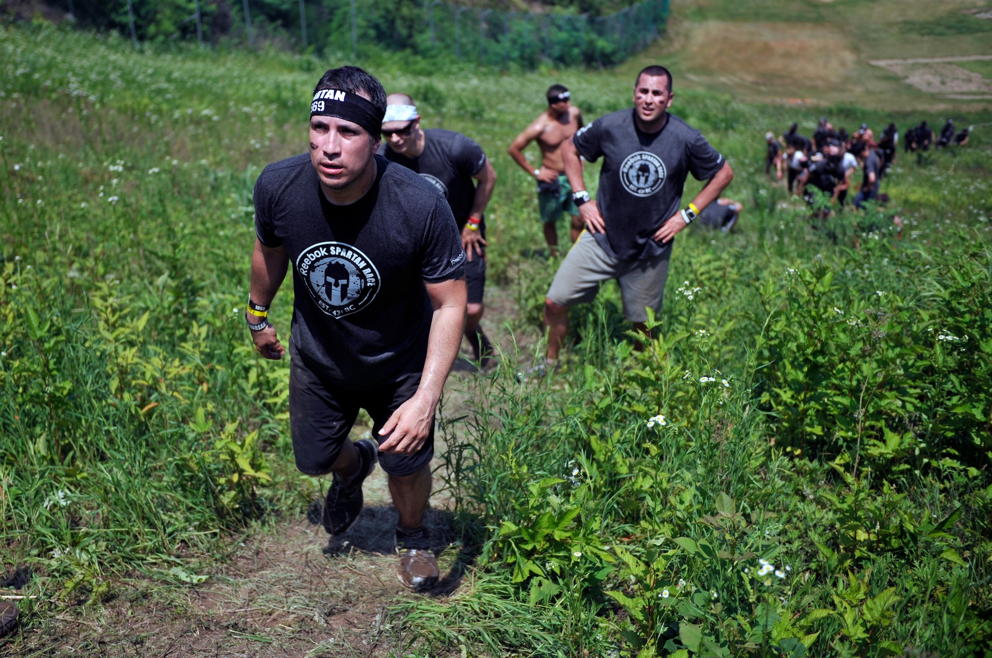 Master Sgt. Alfredo Benavides, 51st Fighter Wing Ground Safety manager, leads the way as participants hike up a hill during a Spartan Race in Seoul, Republic of Korea, June 15, 2014. Participants had to overcome 15 obstacles during the race. (U.S. Air Force photo/Senior Airman David Owsianka)