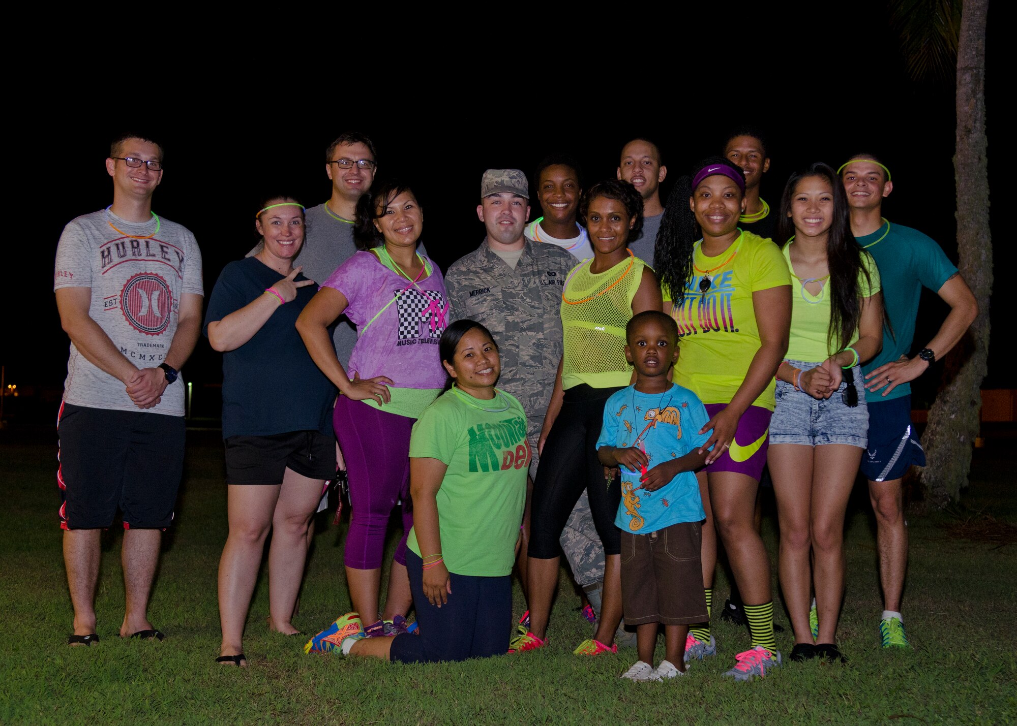 Lesbian, Gay, Bisexual and Transgender Pride Month committee members stand with volunteers after a glow run June 18, 2014, on Andersen Air Force Base, Guam. President Obama issued a proclamation this month recognizing the contributions LGBT Americans make to the Department of Defense. (U.S. Air Force photo by Senior Airman Katrina M. Brisbin/Released)