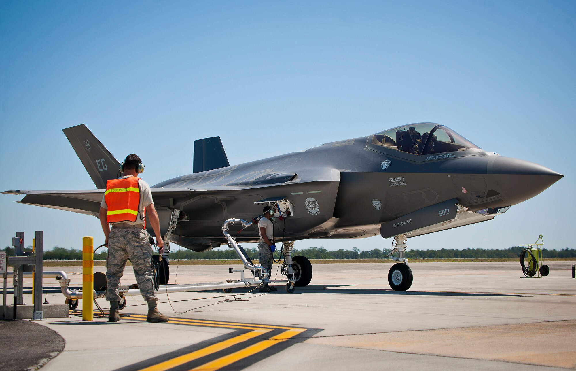 Staff Sgt. Matthew Reed provides oversight for Staff Sgt. Mark Freeman, 33rd Aircraft Maintenance Squadron, during hot pit refueling at Eglin Air Force Base, Fla.  All of the F-35 variants use the refueling areas in conjunction with the 96th Logistics Readiness Squadron’s fuels flight.  (U.S. Air Force photo/Samuel King Jr.)