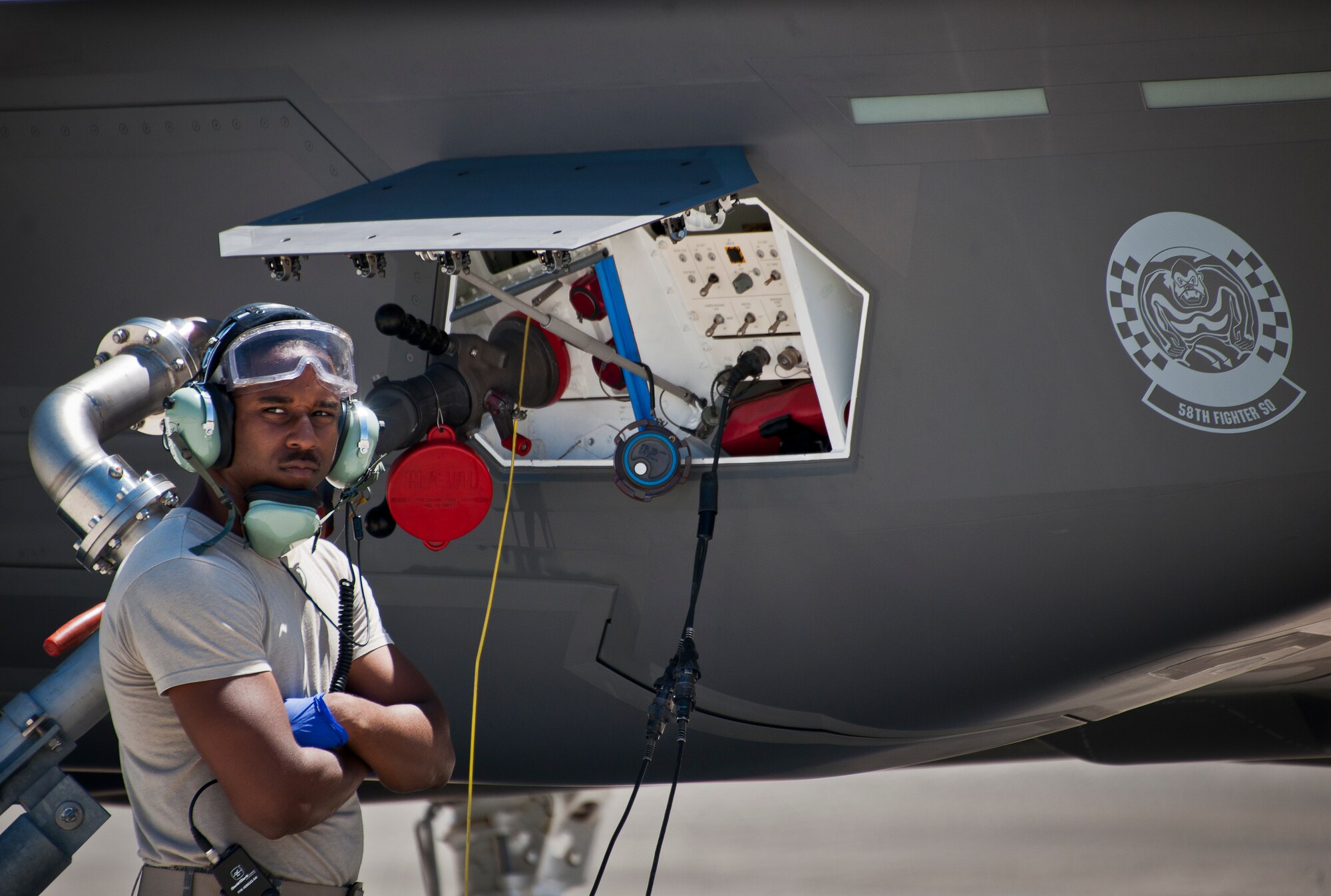Staff Sgt. Mark Freeman, 33rd Aircraft Maintenance Squadron, waits as an F-35A Lightning II takes on fuel at Eglin Air Force Base, Fla.  All of the F-35 variants use the “hot pit” refueling areas in conjunction with the 96th Logistics Readiness Squadron’s fuels flight.  (U.S. Air Force photo/Samuel King Jr.)