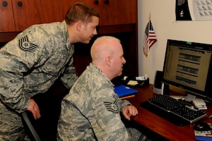 140621-Z-EZ686-019 --  TSgt Hart Haire and TSgt Bryon Harvey of the 127th Logistic Readiness Squadron are working on a log module at Selfridge Air National Guard Base Mich., on June 21, 2014.  Log module is used in the process of building a schedule for every mobilization.   (U.S. Air National Guard photo by MSgt. David Kujawa/Released)