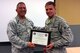 Lt. Col. Paul Novello, left, commander, 108th Civil Engineers Squadron, presents the U.S. Air Force Air Education and Training Command Commander's Award to Airman 1st Class Matthew Covell at the CES commander's call at Joint Base McGuire-Dix-Lakehurst, N.J., June 21, 2014. Covell was presented with the USAF AETC Commander's Award for being a top graduate with superior academic achievement and high standards of leadership, teamwork, and character at the Electrical Systems Apprentice course at Sheppard Air Force Base, Texas. Covell was also presented with a Letter of Appreciation from Sheppard AFB's Chaplain Corps for volunteering at various community services both on and off the base. (U.S. Air National Guard photo by Tech. Sgt. Armando Vasquez/Released)
