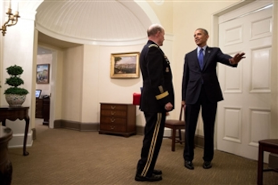 President Barack Obama talks with Army Gen. Martin Dempsey, Chairman of the Joint Chiefs of Staff, outside the Oval Office following a meeting in the Situation Room at the White House, June 19, 2014. 