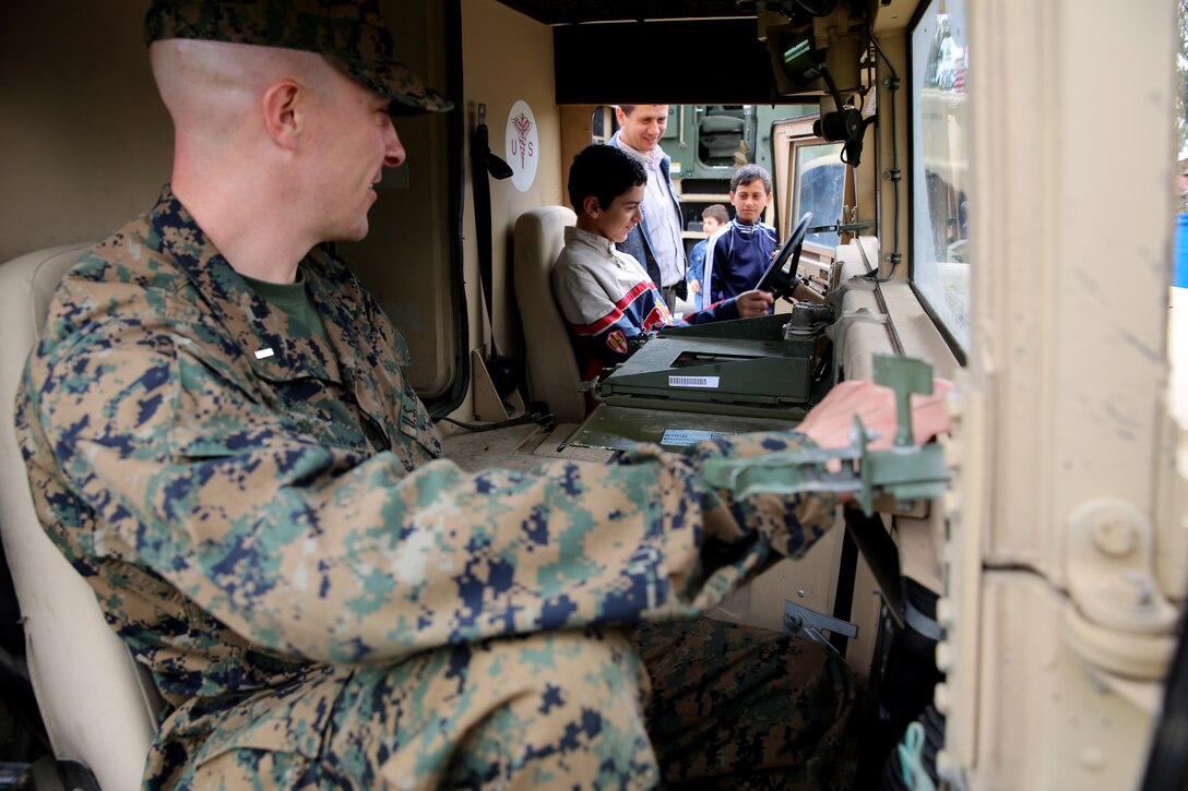 First Lt. Adam Fountain, a ground intelligence officer with Black Sea Rotational Force 14, from 3rd Battalion, 8th Marine Regiment, shows children the inside of a medical Humvee while Marines and sailors visited a local park in Constanta, Romania during Children’s Day weekend with the community May 31, 2014. Marines and sailors participated in Romania’s Children’s Day with a showcase of standard-issued equipment and military vehicles for children to interact with first-hand. The observation promotes mutual exchange and understanding among children while encouraging actions to benefit and promote the welfare of the nation’s children. (Official Marine Corps photo by Lance Cpl. Scott W. Whiting, BSRF PAO/ Released)