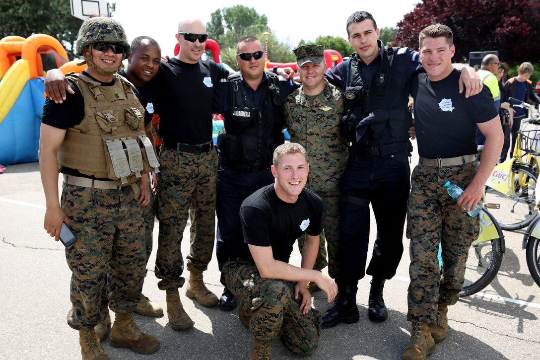 Marines and sailors with Black Sea Rotational Force 14, from 3rd Battalion, 8th Marine Regiment, pose for a picture with Romanian police officers while the service members visited a local park in Constanta, Romania during Children’s Day weekend with the community May 31, 2014. Marines and sailors participated in Romania’s Children’s Day with a showcase of standard-issued equipment and military vehicles for children to interact with first-hand. The observation promotes mutual exchange and understanding among children while encouraging actions to benefit and promote the welfare of the nation’s children. (Official Marine Corps photo by Lance Cpl. Scott W. Whiting, BSRF PAO/ Released)