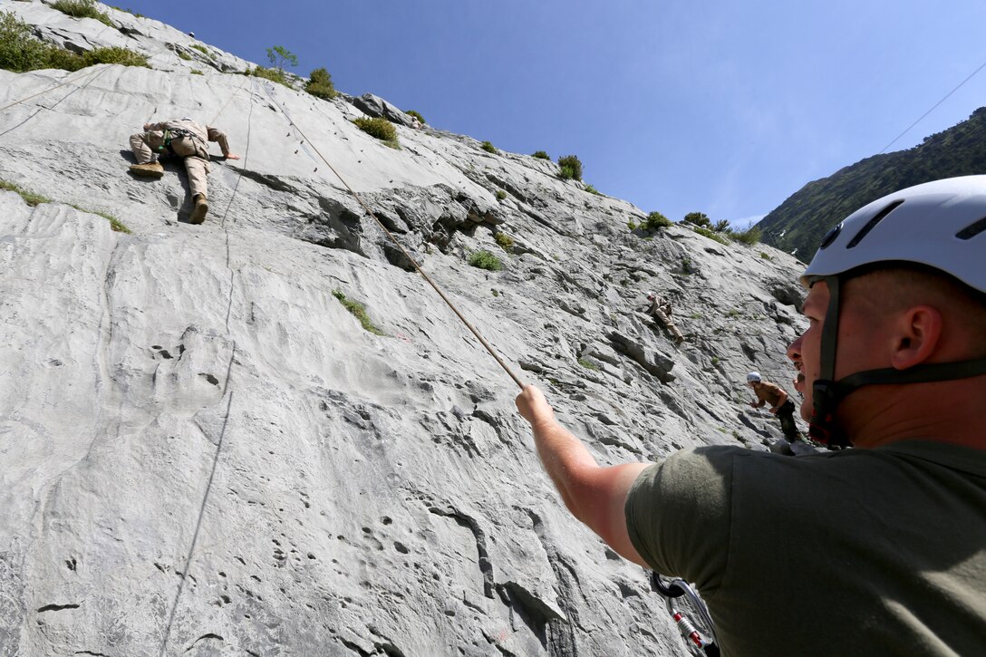 Lance Cpl. Nicholas Wilson, a rifleman with Kilo Company, 3rd Battalion, 8th Marines, Special-Purpose Marine Air-Ground Task Force Crisis Response, (right) provides rope security while Lance Cpl. Jared Wynn ascends up a rock face during a bilateral training exercise at the Candanchú Mountain Training Camp, Spain, June 11, 2014. The training was conducted by the Spanish and American forces in an effort to demonstrate their commitment to military friendship, strategic partnership and regional and global security. (U.S. Marine Corps photo by Lance Cpl. Alexander Hill/Released)