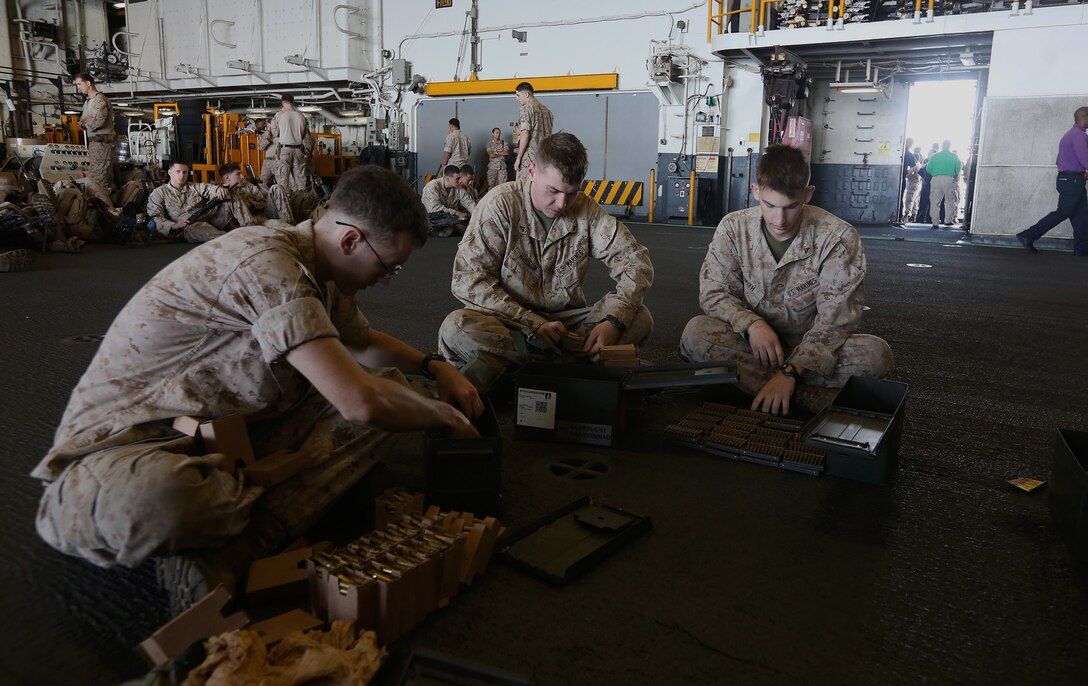 U.S. Marines with  Battalion Landing Team 1st Battalion, 6th Marine Regiment, 22nd Marine Expeditionary Unit (MEU), count ammunition aboard the USS Bataan (LHD 5), at sea, May 30, 2014. Elements of the 22nd MEU, embarked aboard Bataan, are operating in the U.S. 6th Fleet area of operations to augment U.S.  Crisis Response forces in region. (U.S. Marine Corps photo by Lance Cpl. Caleb McDonald/Released)