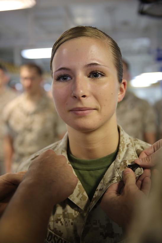 U.S. Marine Corps Cpl. Erika Madson, 22nd Marine Expeditionary Unit (MEU) analyst and native of Norfolk, Va., is promoted to her current rank during a meritorious promotion ceremony aboard the USS Bataan (LHD 5), at sea, June 2, 2014. The MEU is deployed to the U.S. 6th Fleet area of operations with the Bataan Amphibious Ready Group as a sea-based, expeditionary crisis response force capable of conducting amphibious missions across the full range of military operations. (U.S. Marine Corps photo by Sgt. Alisa J. Helin/Released)