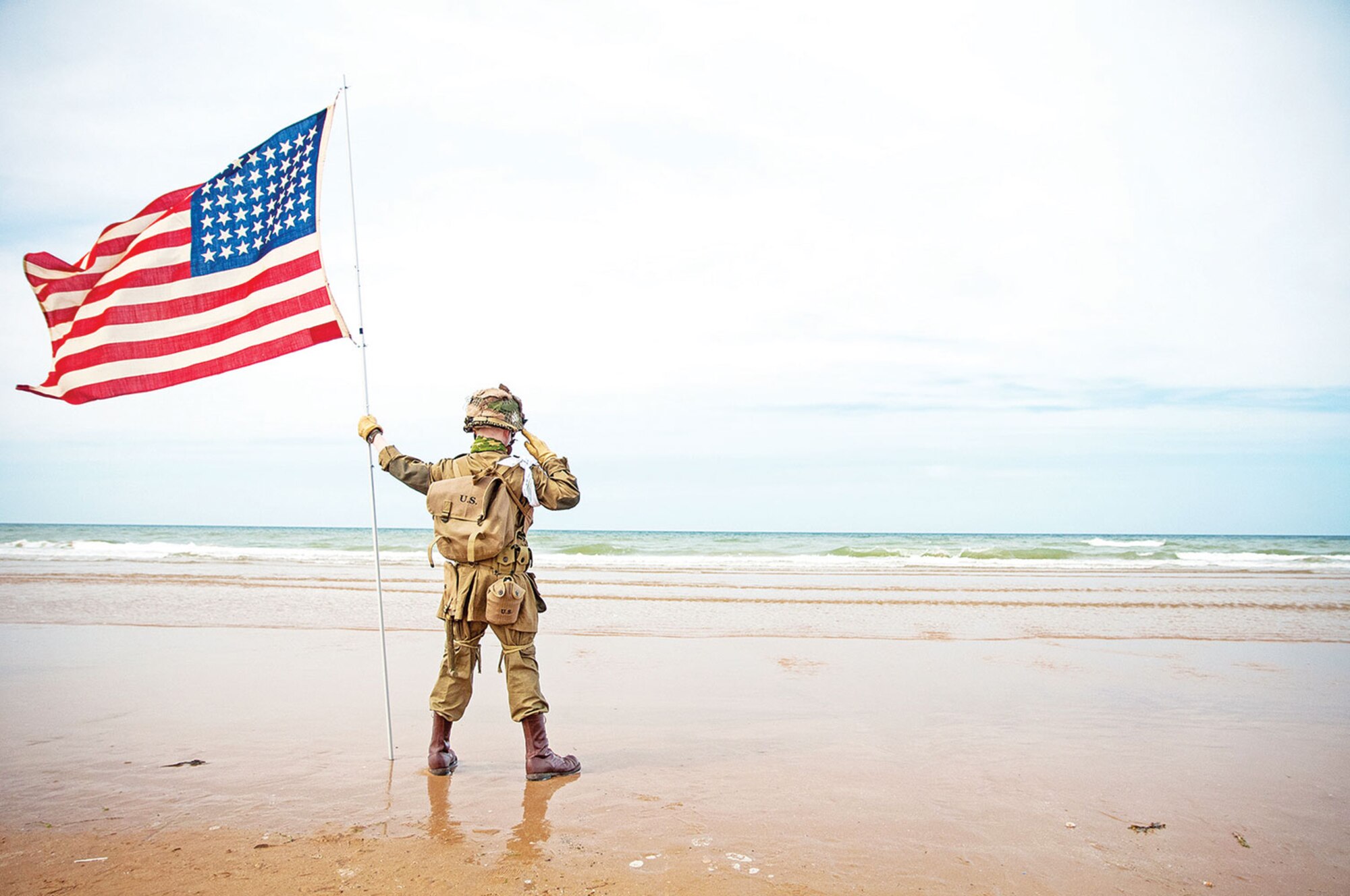 A French child, dressed as an American World War II Soldier, stands tall June 6 while saluting the sands of Omaha Beach, France. The boy, never breaking composure, stood for more than two hours during a 1st Inf. Div. ceremony that helped commemorate the 70th anniversary of the D-Day landings. 