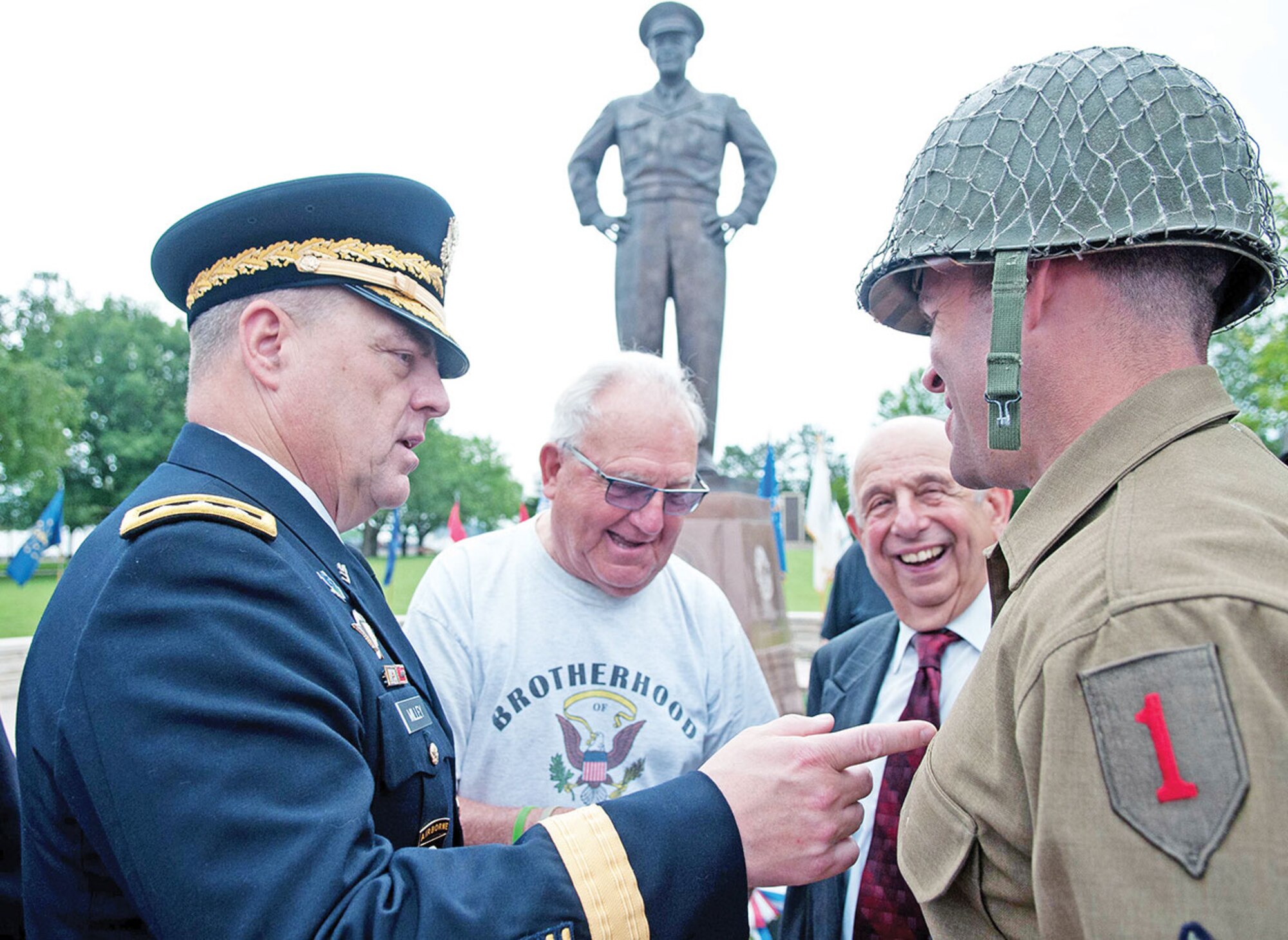 Lt. Gen. Mark A. Milley, III Corps commander, talks to two Kansas World War II veterans about the uniforms they wore during the June 6 70th anniversary of D-Day at the Eisenhower Presidential Library, Museum and Boyhood Home in Abilene, Kan. Soldiers from the 1st ABCT, wore period World War II uniforms during the event. 