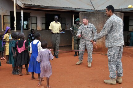 Army Sgt. Enrique Icedo (right) and Army 1st Lt. Victor Lauersdorf, members of Task Force Raptor, 3rd Squadron, 124th Cavalry Regiment, Texas Army National Guard, visit a local school near the Ugandan Peoples Defense Forces training center here April 3, 2012. The Guard members are conducting various military-to-military training sessions in support of Combined Joint Task Force-Horn of Africa, whose mission is to build partnerships with nations in East Africa.