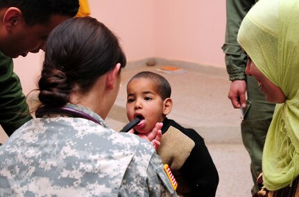 Army 1st Lt. Emily S. Smith, a physician assistant from the Utah State Medical Command, Utah Army National Guard, gives a Moroccan boy a checkup at the Humanitarian Civil Assistance site in Sidi Mussa, Morocco April 13, 2012. The HCA is part of African Lion 2012, an annual, bilateral exercise where U.S. and Moroccan forces work side-by-side to learn each other's tactics and operational procedures.