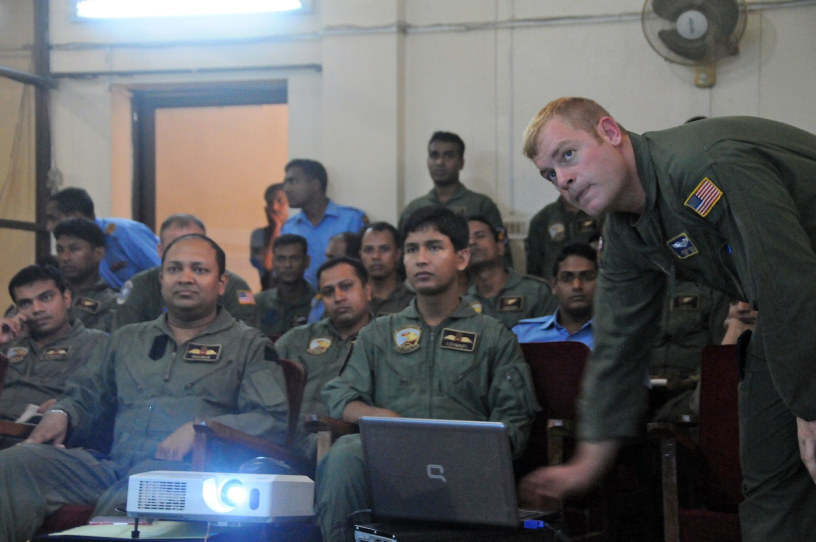 Air Force Tech. Sgt. Joshua Shelby, a loadmaster with the 123rd Airlift Wing, Kentucky Air National Guard, shares his knowledge of heavy equipment airdrop procedures with an audience of more than 20 Bangladesh air force airmen at Kurmitola Air Base, Bangladesh April 22, 2012.