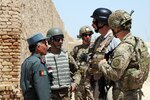 Lt. Col. Abdul Qayoum Azami, Farah City prison warden (left), leads a tour of the prison in Farah City, Farah province, Afghanistan, April 24, 2012. Coalition members are visiting the prison to observe and provide recommendations to improve conditions.