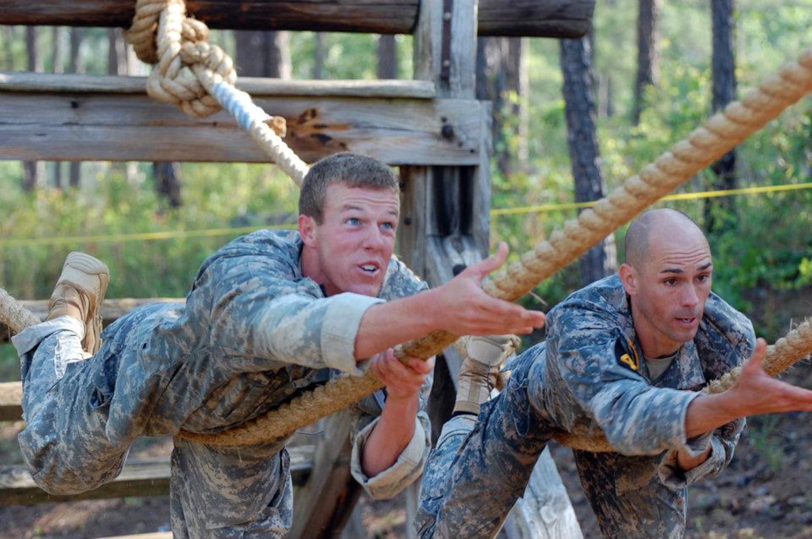Team 49 during the 29th Annual David E. Grange, Jr. Best Ranger Competition at Fort Benning, Ga., April 13, 2012, made up of (left to right) Army 1st Lt. Nicholas Plocar with the Wisconsin Army National Guard and Army Capt Robert Killian with the Colorado Army National Guard, complete the commando crawl obstacle during the first day of the. Killian and Plocar placed sixth overall in the competition.
