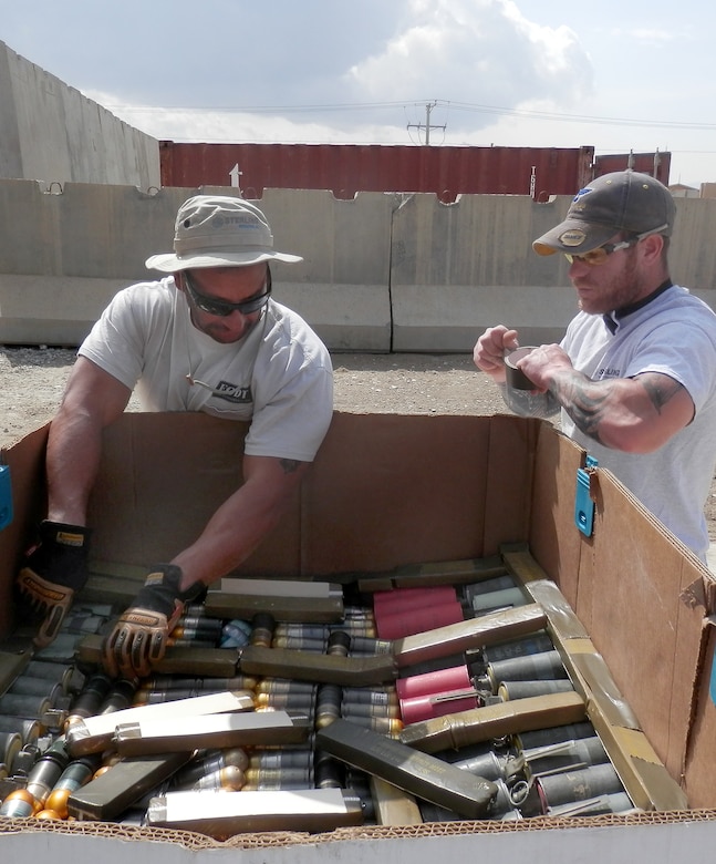 Joint Munitions Disposal-Afghanistan personnel build an ammunition shot box and place C-4 over the unserviceable ammo scheduled to be destroyed, paying particular attention to the continuity of the explosives and ammo. It is then taped in place for extra security from movement to the range for demolition.
