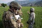 Army Capt. James Schmitz of the Wisconsin National Guard's 82nd Agribusiness Development Team jots a few notes in his notebook about crop conditions at a demonstration farm in Watapur Province, Afghanistan, April 16,2012. The 82nd ADT was at the farm to perform quality assurance checks of the farm's operations, assess crop health and identify future farm issues.