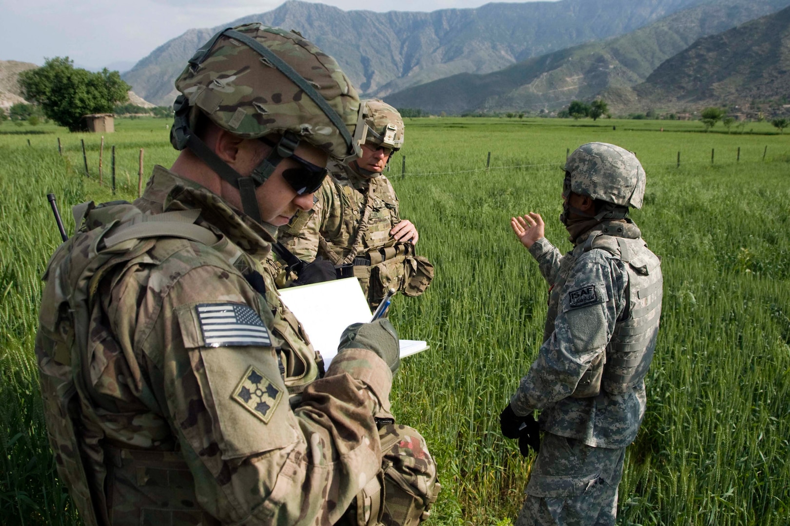 Army Capt. James Schmitz of the Wisconsin National Guard's 82nd Agribusiness Development Team jots a few notes in his notebook about crop conditions at a demonstration farm in Watapur Province, Afghanistan, April 16,2012. The 82nd ADT was at the farm to perform quality assurance checks of the farm's operations, assess crop health and identify future farm issues.