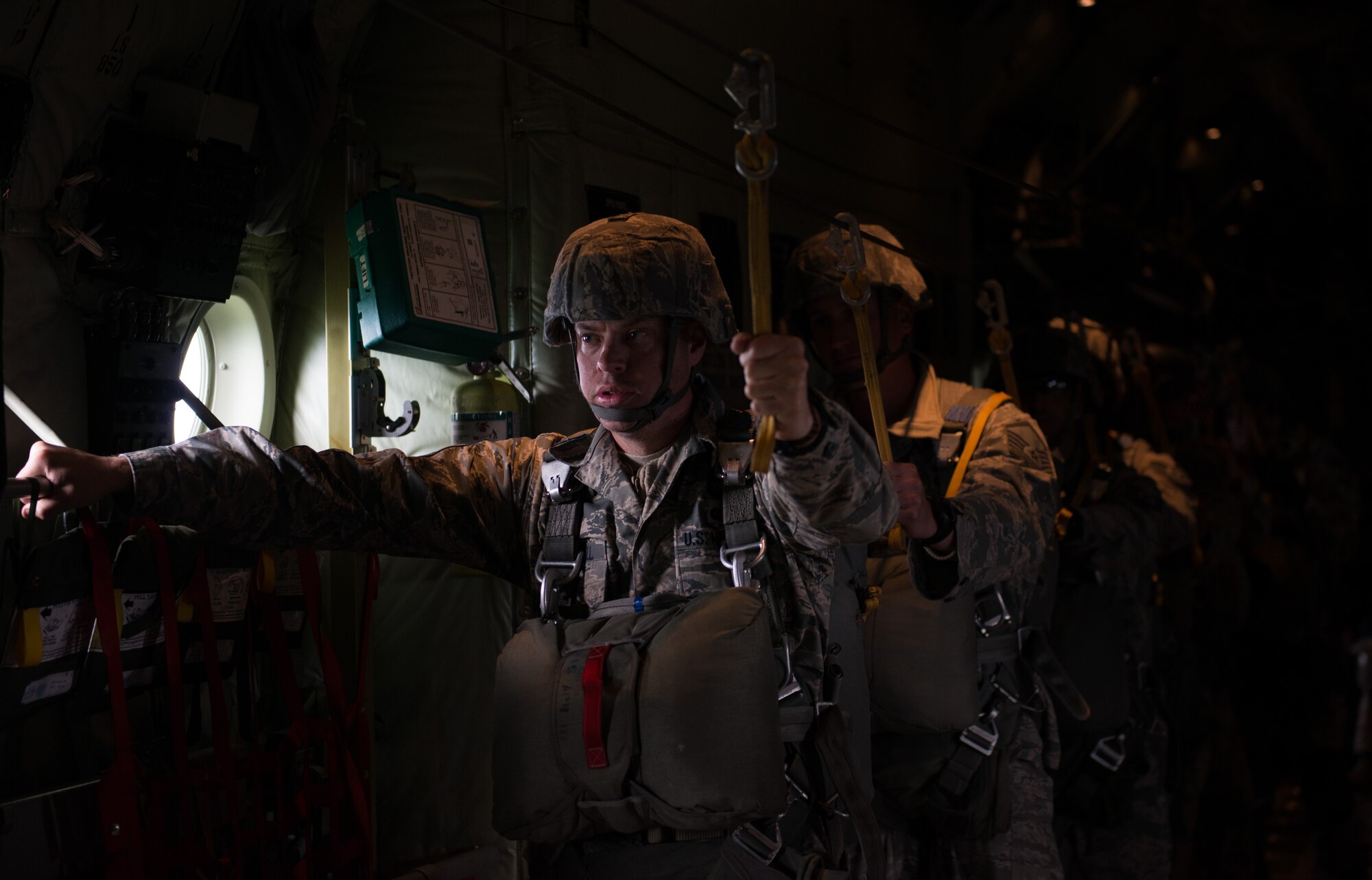 Tech. Sgt. Brian Angell waits to jump out of a C-130J Hercules during the Air Force-specific portion of Saber Strike June 17, 2014, on Lielvarde Air Base, Latvia. During the final week of Saber Strike 2014 the 435th Contingency Response Group, in conjunction with the 37th Airlift Squadron, trained on the full capabilities to open the Latvian air base. They also trained with Latvian and Estonian service members on airfield operations, command and control of air and space forces, weather support, and protection of operational forces, aircraft maintenance, and aerial port services. Angell is the 435th CRG personnel parachute program manager. (U.S. Air Force photo/Senior Airman Jonathan Stefanko)