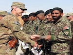 Army 1st. Lt. Aaron Graves presents Afghan National Army Spc. Menawal his certificate of completion March 24, 2012 for maintenance training completed at Forward Operating Base Gamberi.