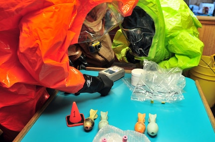 Members of the joint Civil Support Team collect, mark and bag unknown chemical samples on the suspected terrorist tugboat Pono during a simulated training event in Honolulu, April 24, 2012.