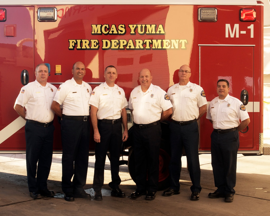 The Marine Corps Air Station Yuma, Ariz., fire department celebrated their achievement as the DoD Fire Prevention Program of the Year for 2013 after competing against other Marine Corps installations, May 14. The staff, (from left to right) Fire Inspectors James Taylor and Ricardo Pastrana, Fire Chief Michael Batson, Assistant Fire Chief J.C. Summers, Fire Inspectors Jeff Kindler and Greg Lopez, pose for a photo in front of their emergency vehicle, Jan. 13. Photo by: Lance Cpl. Summer Dowding
