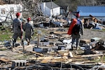 Kentucky National Guard service members engage in a search and rescue mission in West Liberty, Ky., for survivors after torrential storms and violent winds destroyed much of the community there, March 2, 2012.