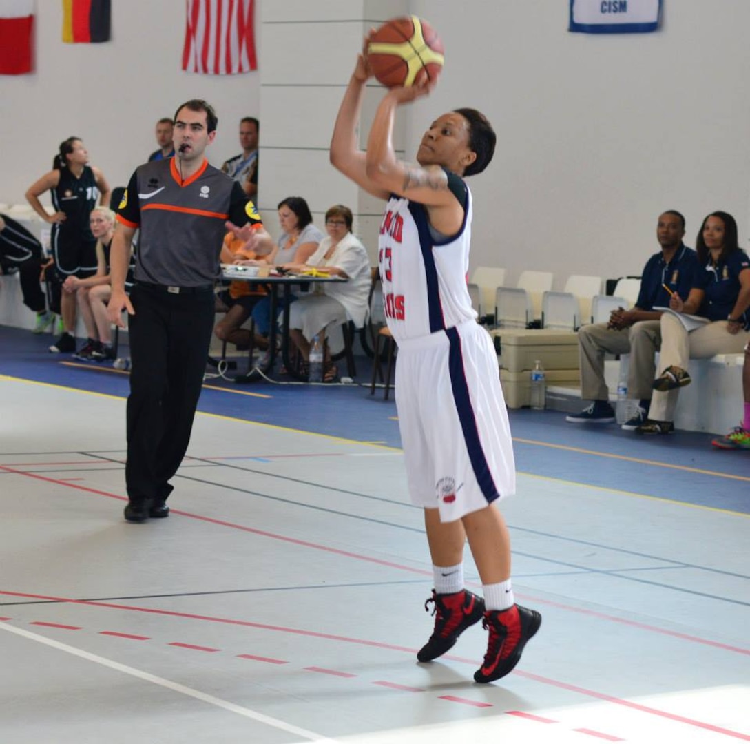 Navy Petty Officer 3rd Class Talena Faison (San Diego, CA) hits the 3-pointer vs. Germany.  The U.S. Armed Forces Women’s Basketball team competed in the 2014 Conseil International du Sport Militaire (CISM) Basketball Championship in Meyenheim, France from 15-22 June.