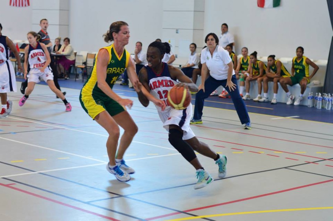 Army SGT Kimberly Smith (Fort Riley, KS) drives past her Brazilian defender.  The U.S. Armed Forces Women’s Basketball team competed in the 2014 Conseil International du Sport Militaire (CISM) Basketball Championship in Meyenheim, France from 15-22 June.