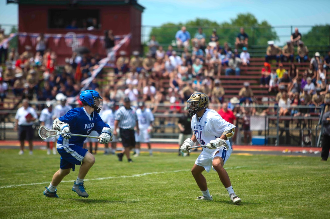 GLEN COVE, N.Y. -- Team Valor faces off against team Virtue in the Inaugural Dan Daly Cup at Glen Cove High School’s  Maiden Field, June 21. The Dan Daly Cup is a lacrosse game thrown in honor of Sgt. Maj. Dan Daly, a recipient of two Medals of Honor, in his home town of Glen Cove. (U.S. Marine Corps photo by Lance Cpl. Brandon Thomas) 