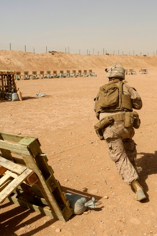Lance Cpl. Jonathan Hance, a machine gunner with 1st Battalion, 2nd Marine Regiment, and a Hickory, N.C., native, runs to the next firing position during a combat marksmanship range held aboard Camp Leatherneck, Helmand province, Afghanistan, June 20, 2014. Ranges such as this one keep Marines like Hance, a Hickory, N.C., native, on top of their shooting skills and give them the confidence they need while on a patrol. (U.S. Marine Corps photo by Cpl. Michael Dye/released)