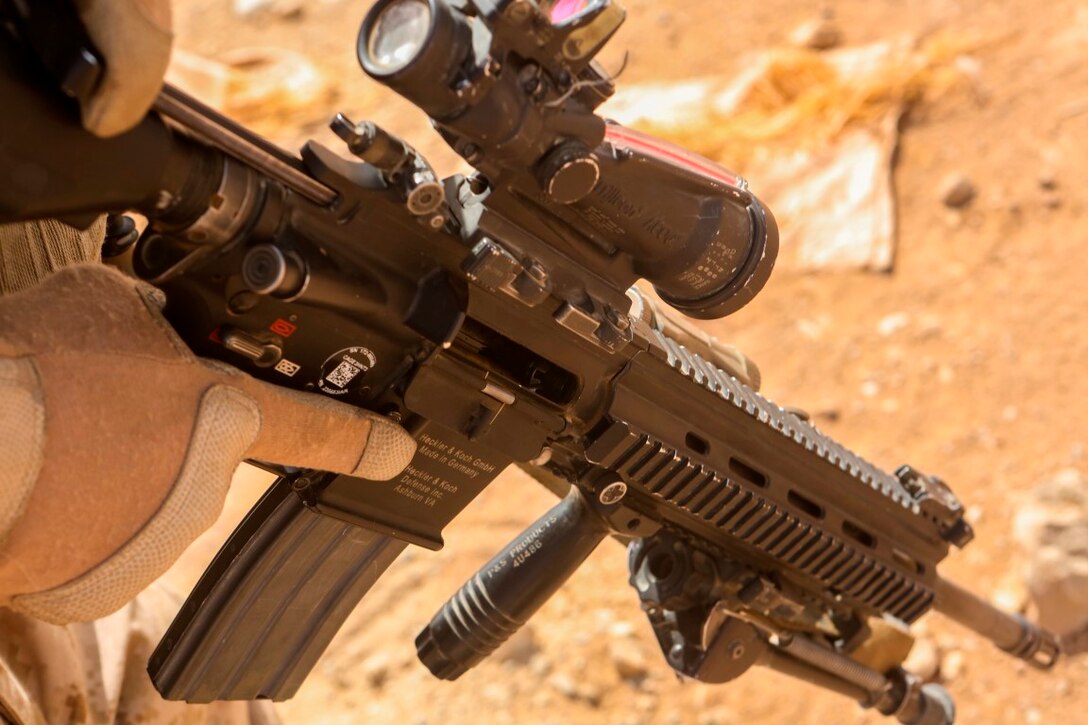 A Marine with 1st Battalion, 2nd Marine Regiment, prepares to load a round into his rifle prior to starting a combat marksmanship range held aboard Camp Leatherneck, Helmand province, Afghanistan, June 20, 2014. Ranges such as this one keep Marines on top of their shooting skills, and give them the confidence they need while on a patrol. (U.S. Marine Corps photo by Cpl. Michael Dye/released)