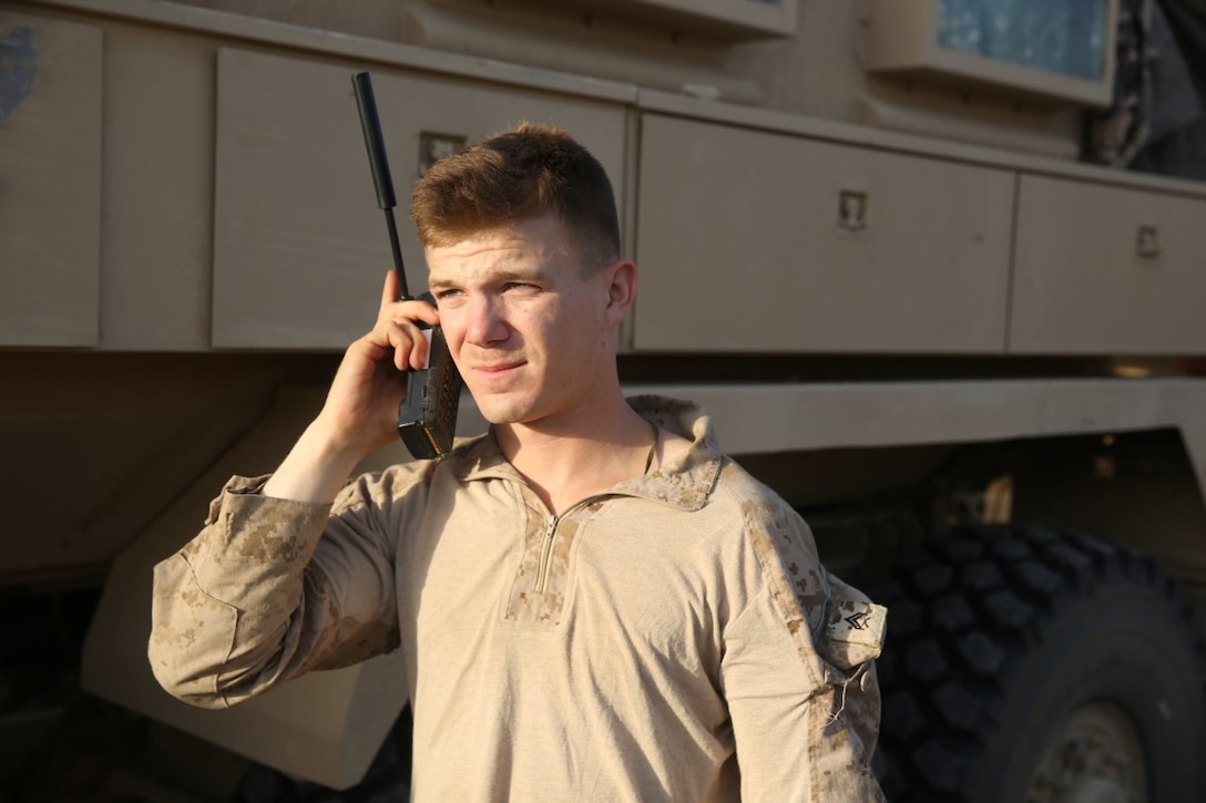 Corporal Mark Rood, cyber network operator, Headquarters and Service Company, 1st Battalion, 7th Marine Regiment, troubleshoots network connectivity from a satellite phone during a mission in Helmand province, Afghanistan, June 13, 2014. Rood, a native of Doylestown, Penn., along with a platoon of infantrymen, provided security at Patrol Base Ouellette, an Afghan National Army controlled-base, during the Afghanistan presidential runoff elections. While International Security Assistance Force stood ready to support as needed, the elections were entirely Afghan led and Afghan conducted.