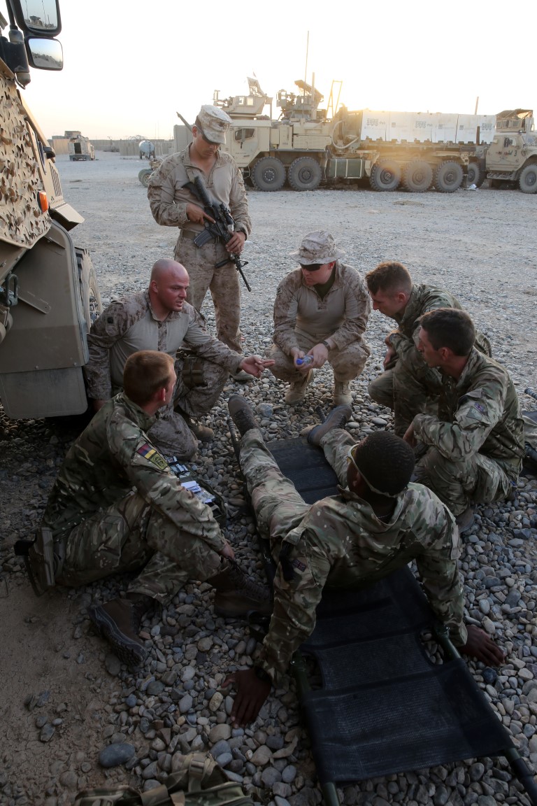 Navy corpsmen with 1st Battalion, 7th Marine Regiment, review medevac procedures with British soldiers during a mission in Helmand province, Afghanistan, June 13, 2014. The corpsmen, along with a platoon of infantrymen, provided security at Patrol Base Ouellette, an Afghan National Army controlled-base, during the Afghanistan presidential runoff elections. While International Security Assistance Force stood ready to support as needed, the elections were entirely Afghan led and Afghan conducted.