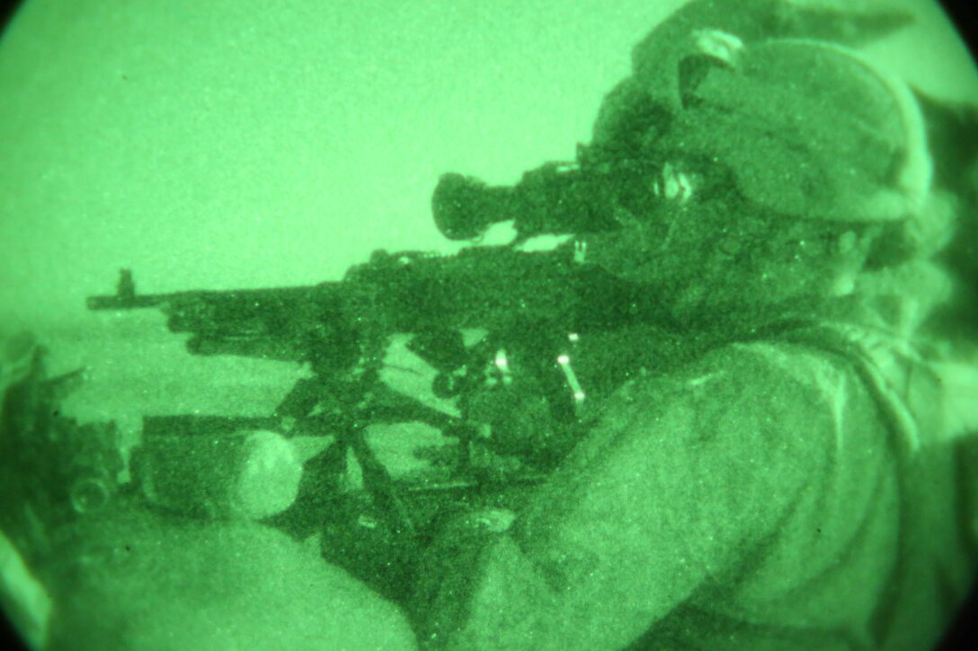 Corporal Domingo Espinal, machine gunner, Weapons Company, 1st Battalion, 7th Marine Regiment, mans a M240B medium machine gun throughout the night from a security post during a mission in Helmand province, Afghanistan, June 13, 2014. Espinal, a native of Athens, Ga., along with a platoon of infantrymen, provided security at Patrol Base Ouellette, an Afghan National Army controlled-base, during the Afghanistan presidential runoff elections. While International Security Assistance Force stood ready to support as needed, the elections were entirely Afghan led and Afghan conducted.